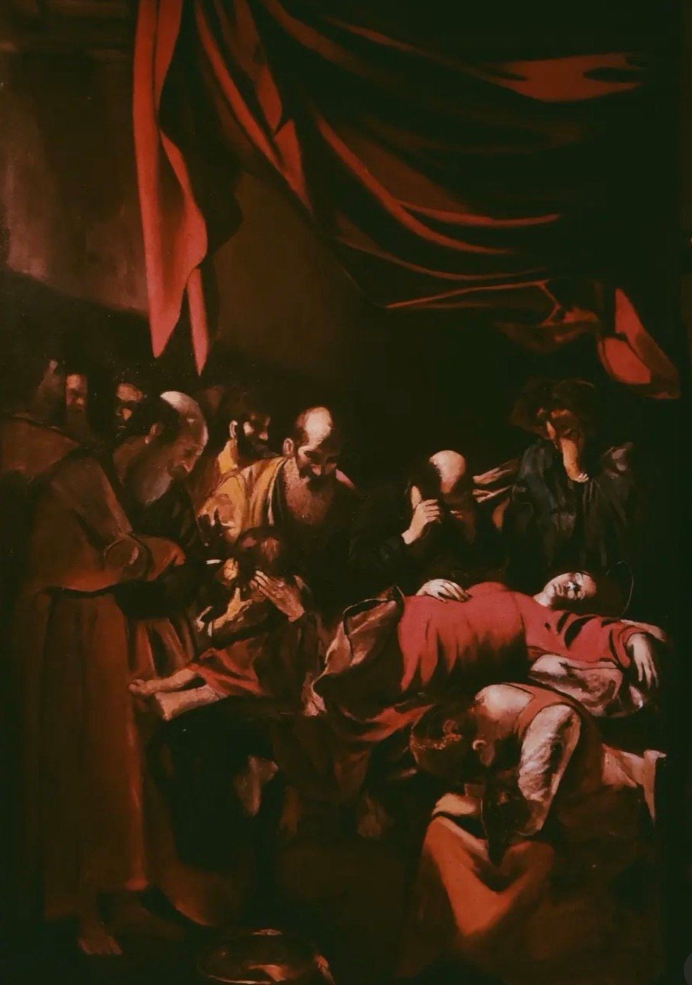Dark, candlelit painting of mourners gathered beneath a red curtain